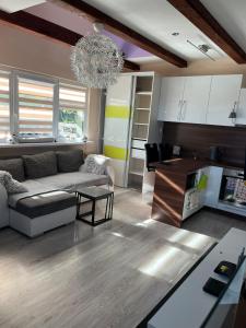 a living room with a couch and a chandelier at Dom pre hostí blízko centra BB in Banská Bystrica