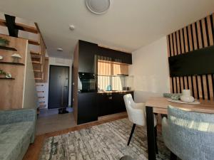 a kitchen and living room with a table and chairs at Vikvid in Kopaonik