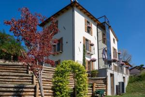 a building with a tree in front of it at CasettaLuce in Cuneo