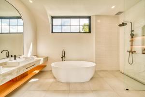 a bathroom with a tub and two sinks and a shower at Senada Garden in Uluwatu +31 photos