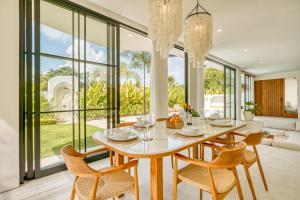 a dining room with a table and chairs at Senada Garden in Uluwatu
