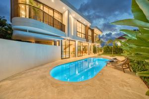 an exterior view of a house with a swimming pool at Senada Garden in Uluwatu