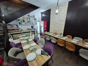 a restaurant with wooden tables and purple chairs at JANO HOUSE AppartHôtel in Djibouti