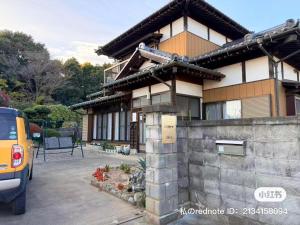a house with a car parked in front of it at Cai 芸術の家 in Tsukuba