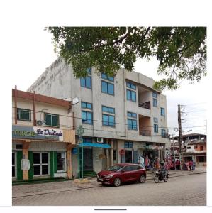 a red car parked in front of a building at EZK Appart in Cotonou
