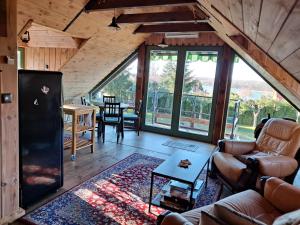 a living room with a couch and a table at Domek Kowboja in Iława