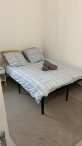 a bed with two pillows on it in a room at Le Nid Chaleureux Ecoresponsable in Sevran +12 photos