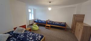 a bedroom with a bed and a bench and a window at Apartment Bärenstein Vejprty in Vejprty