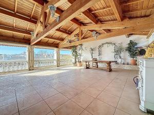 a large living room with a wooden ceiling and a table at Le Mirabeau - Appartement bourgeois - Terrasse 80m2 - Wifi et Climatisation in Narbonne