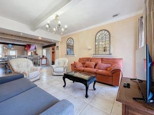 a living room with a couch and a table at Le Mirabeau - Appartement bourgeois - Terrasse 80m2 - Wifi et Climatisation in Narbonne