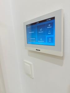 a television is mounted on a wall at Apartament Natura in Piła