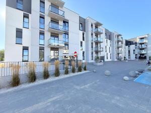 a large apartment building with a courtyard with plants at Apartament Natura in Piła