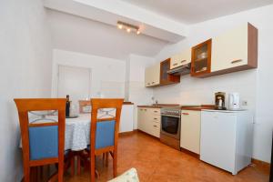 a kitchen with a table and chairs in a room at Apartment LILI in Poreč