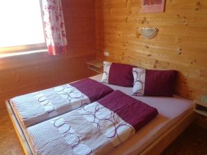 a bedroom with a bed in a wooden room at Ferienhütte Georg in Hippach