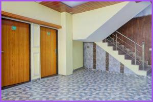 a hallway with two doors and a staircase at Hotel Rangoli Residency Near Sea Beach in Baga