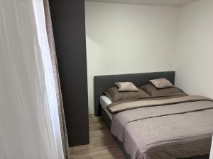 a bedroom with a bed with two pillows on it at Countryside Apartments 252 in Poříčí nad Sázavou
