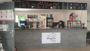 a counter in a coffee shop with a sign on it at Unique, Chambre 2,centre équestre & snacks in Vic-le-Comte +10 photos