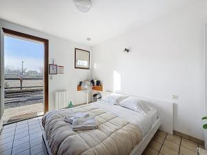 a white bedroom with a large bed and a window at Unique, Chambre 2,centre équestre & snacks in Vic-le-Comte