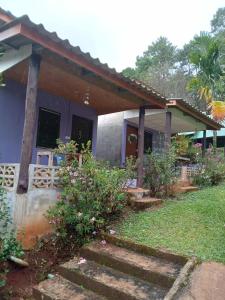 a house with a porch and stairs to it at โบว์ ปางอุ๋ง in Ban Huai Makhuea Som