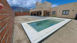a large swimming pool in front of a house at Ribera I in Cafayate