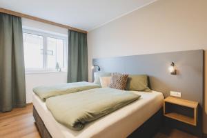 Postel nebo postele na pokoji v ubytování Dorfvilla Niedernsill