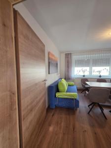 um quarto com um sofá azul e uma mesa em Ferienhaus Helene Güttenbach em Güttenbach