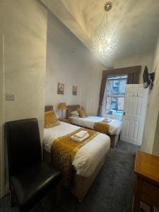 a hotel room with two beds and a chair at Grange Lodge in York