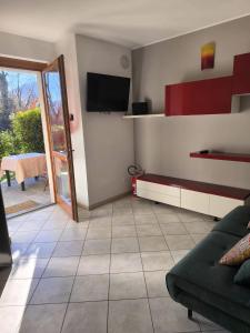a living room with a couch and a tv at Appartamento La Ciliegia in Sovere