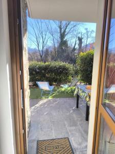 a door to a patio with a table and a chair at Appartamento La Ciliegia in Sovere