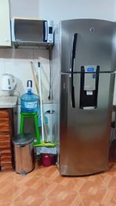 a stainless steel refrigerator in a kitchen with at Departamentos tini in La Punta +2 photos