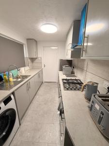 a kitchen with a sink and a stove top oven at Cosy Bungalow house in the centre of Sunderland in Sunderland