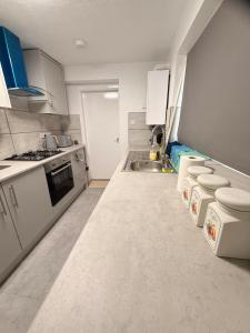 a kitchen with white appliances and a sink at Cosy Bungalow house in the centre of Sunderland in Sunderland
