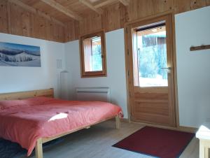 a bedroom with a bed and a door at Studio Mont d'Arbois in Megève