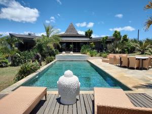 a swimming pool in front of a villa at Cap Nord in Cap Malheureux