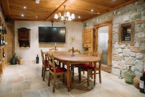 a dining room with a wooden table and chairs at Alpenblick Weggis - Panorama & Alpen Chic Hotel in Weggis +15 photos