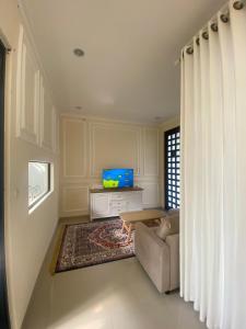 a living room with a couch and a table at Omah Sulaem Homestay in Malang