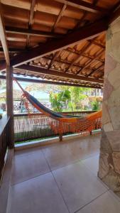 a hammock hanging from a roof in a building at Flor de Lótus - Vista ao mar in Ilha de Boipeba
