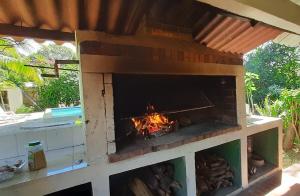 a brick oven with a fire inside of it at Casa jardín nueva gorgona in Nueva Gorgona