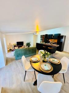 a living room with a table and chairs at L écrin secret de Foix in Foix +19 photos