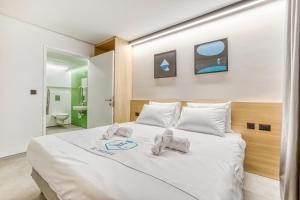 a bedroom with a large white bed with white pillows at JL Hotel in St. Julianʼs