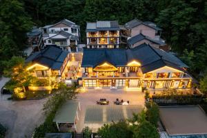 an aerial view of a large house with lights at Jade Peak Hot Spring Villa in Dujiangyan