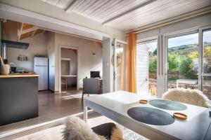 a living room with a table and a kitchen with a view at Casa Boletes, with splendid views! in Cartagena