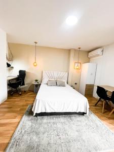 ein Schlafzimmer mit einem großen weißen Bett mit einem Teppich in der Unterkunft Apto estudio moderno cerca a centros comerciales in Yopal + 5 Fotos