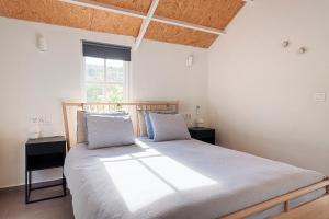 a bedroom with a large bed and a window at Casa Boletes, with splendid views! in Cartagena