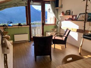 a living room with a large window and a table and chairs at Dachstein Stüberl in Bad Aussee
