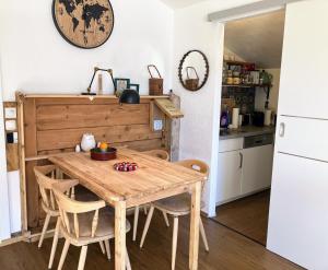 a kitchen with a wooden table and chairs at Dachstein Stüberl in Bad Aussee