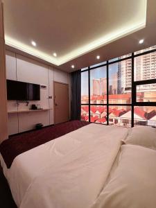 Ένα ή περισσότερα κρεβάτια σε δωμάτιο στο 游子酒店