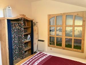a bedroom with a bed and a window at Dachstein Stüberl in Bad Aussee