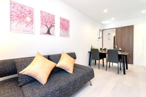 a living room with a couch and a dining room at sunshin dream in Osaka
