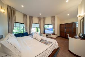 a bedroom with a large white bed and a television at Chaweng Bay View Resort by Smith & Appy in Ko Samui +231 photos